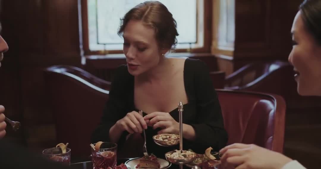A group sharing dinner and conversation around a restaurant table